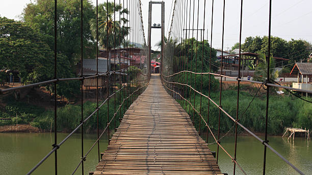 istock Rope wooden bridge to village 465501925