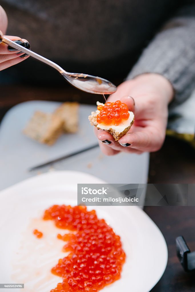 Caviar Preparation of red caviar in domestic kitchen, shallow depth of field, focus on the caviar 2015 Stock Photo