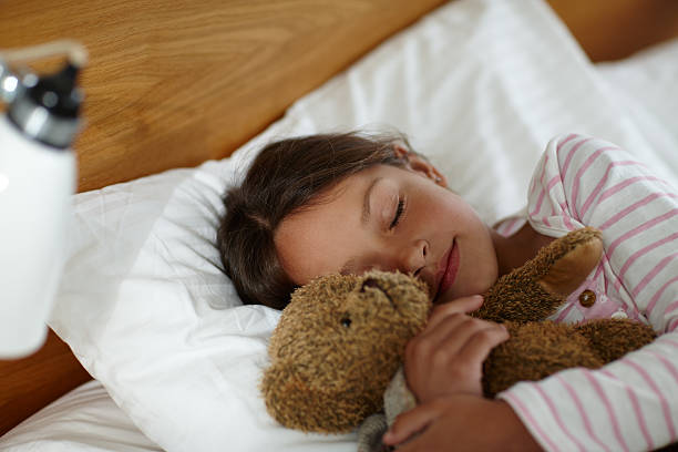 istock Sweet dreams with teddy by her side 465503552