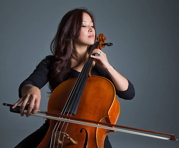 Female Cellist Playing Cello stock photo