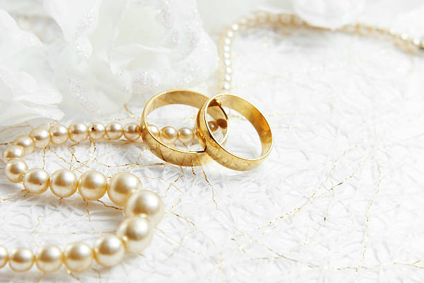 istock Two golden wedding rings with seamless flower decorations 465504778