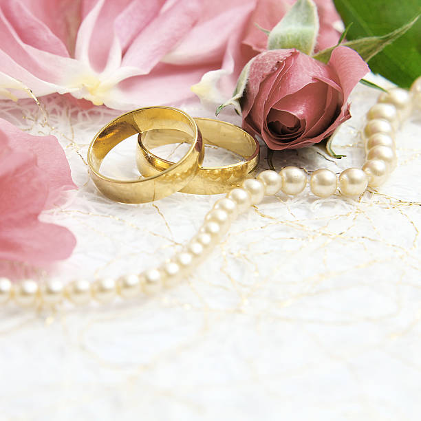 istock pair of wedding rings with roses for background image 465504786