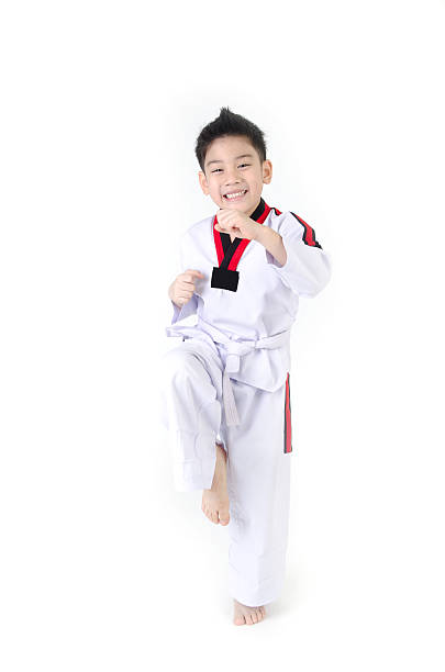 Taekwondo action  by a asian cute boy stock photo
