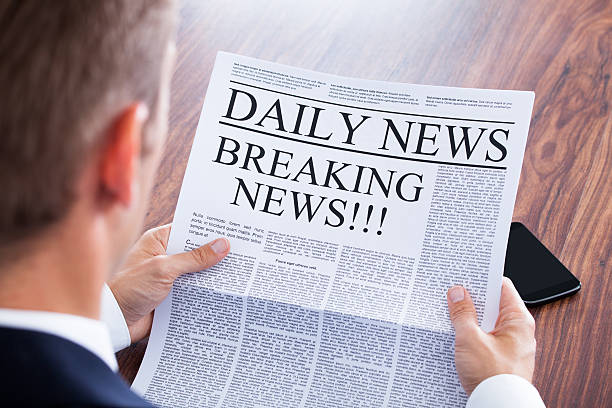 Young Businessman Reading Breaking News Young Businessman Reading Breaking News On Newspaper reading newspaper stock pictures, royalty-free photos & images