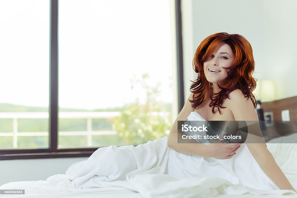 woman in bed beautiful red hair woman in morning time sitting in bed. 20-29 Years Stock Photo