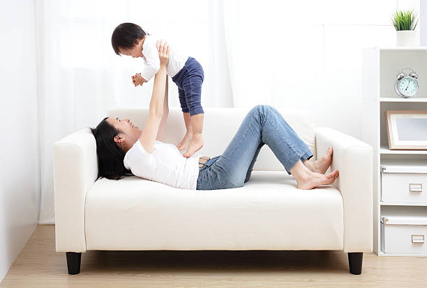 istock A mother playing with her baby on a sofa 465508895