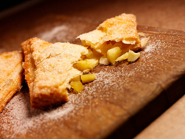 istock apple turnover desert opened up on a wooden chopping board 465508939