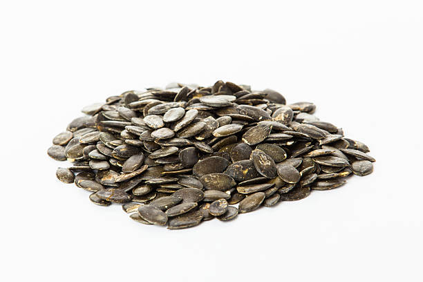istock pumpkin seeds isolated on white background. Fresh roasted Pumpki 465509164