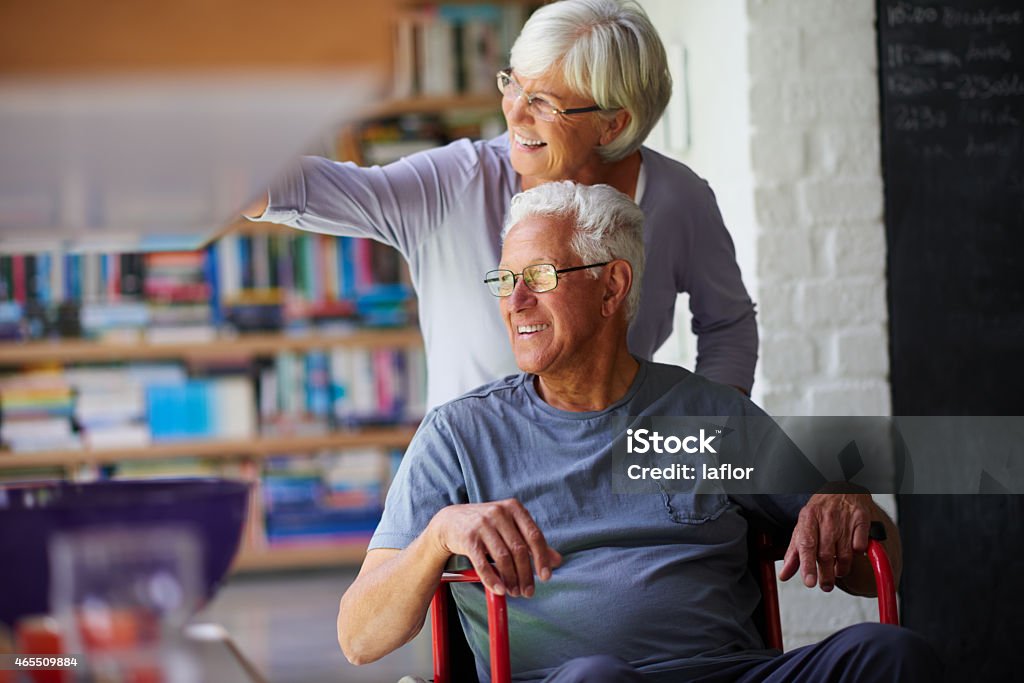 Nothing gets us down Shot of a senior woman pushing her husband in a wheelchair at homehttp://195.154.178.81/DATA/istock_collage/a4/shoots/785189.jpg 2015 Stock Photo