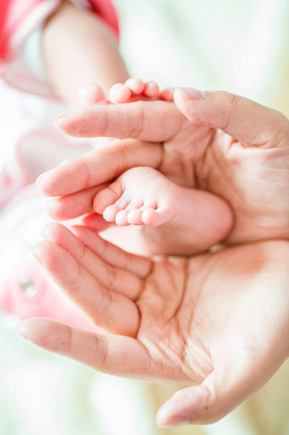 istock Mommy Holding Baby's Feet 465510077