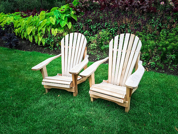 istock Wooden chairs on green lawn 465510108