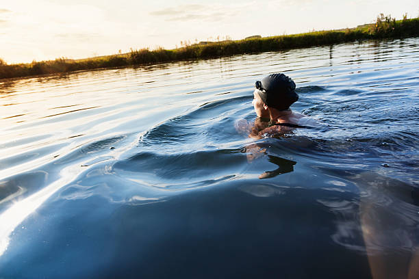 istock woman swimmer in river 465511135