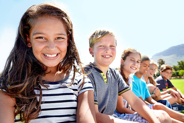 Portrait of a group of young children enjoying a day outside