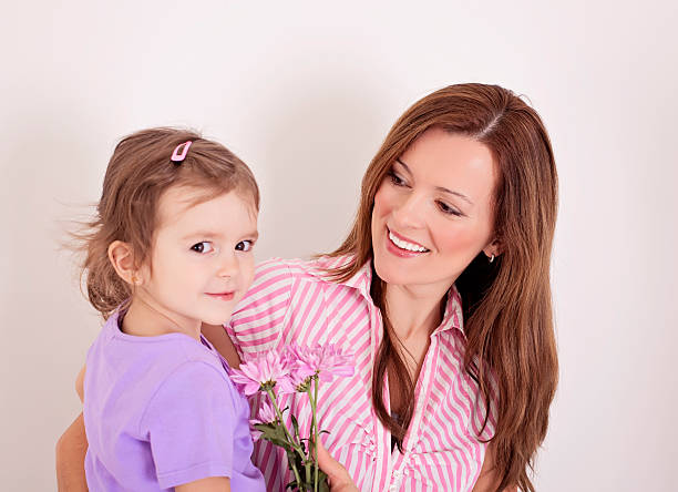 istock Mother and daughter with flowers 465511961