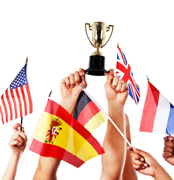 istock International competition: hands with mixed flags and trophy held high 465512309