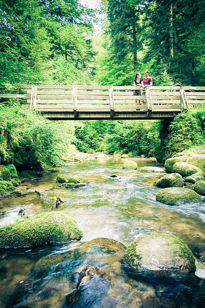 young couple hiking through the forest