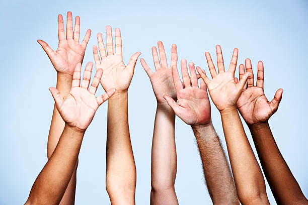 istock Seven enthusiastic volunteers put their hands up 465512837