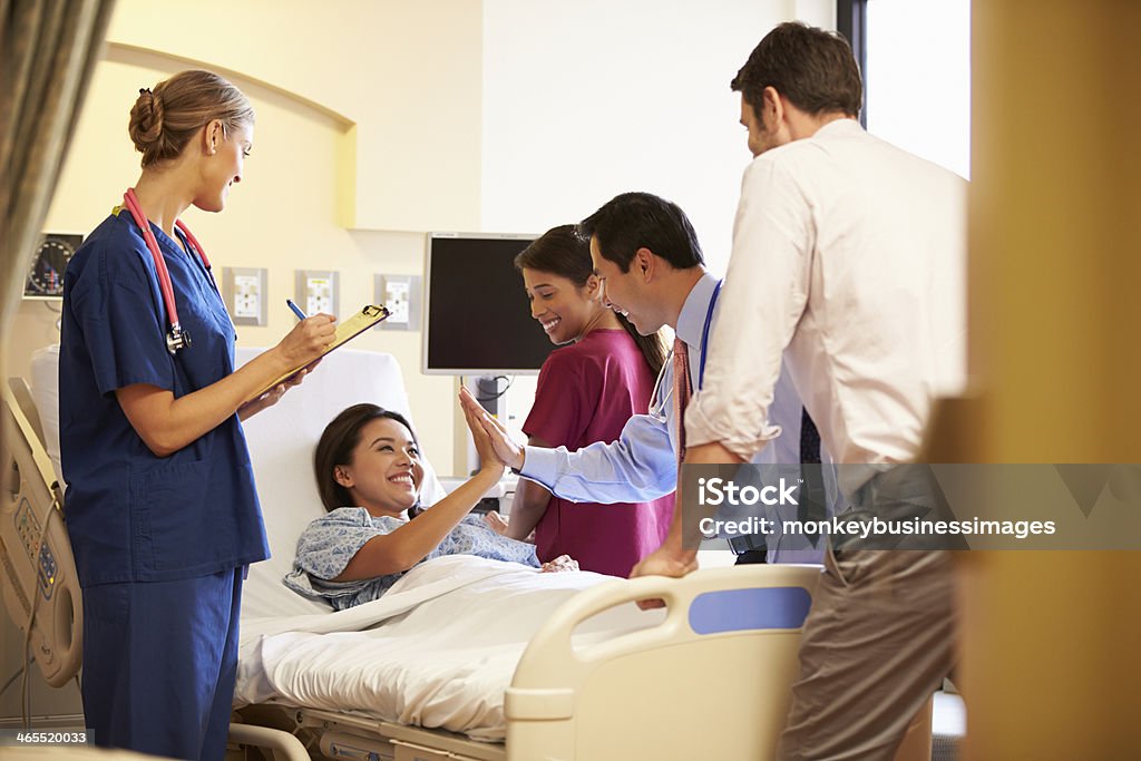 Medical Team Meeting Around Female Patient In Hospital Room Happy Smiling Medical Team Meeting Around Female Patient In Hospital Room Patience Stock Photo