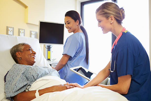 istock Nurse with tablet talking to senior woman 465520331
