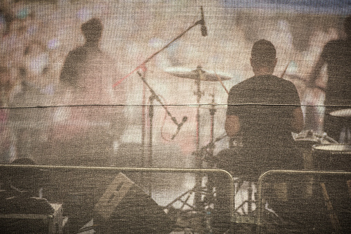 Band performing live on a stage, in front of huge crowd