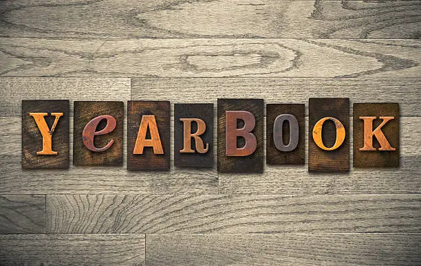 The word "YEARBOOK" written in vintage wooden letterpress type.