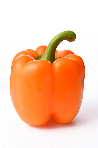 Photo of Isolated shot of orange bell pepper on white background
