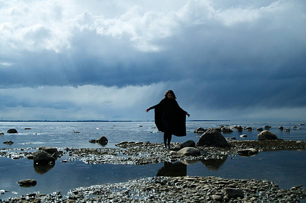 istock girl on a rocky shore 465522186