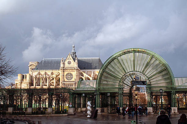 The Halles Entrance Paris, France - February 15, 2006: Entrace to the Les Halle market with the Church of St. Eustace in the background. market hall stock pictures, royalty-free photos & images