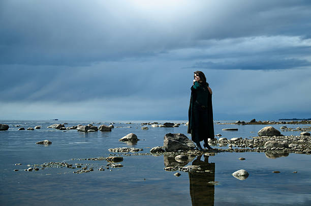 istock girl on a rocky shore 465524718