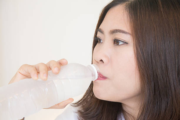 istock Young asian woman drinking water 465524768