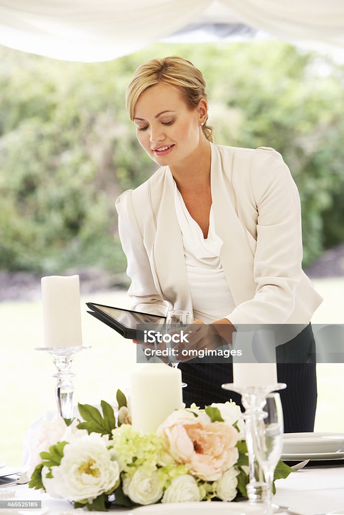 Wedding Planner Checking Table Decorations In Marquee Female Wedding Planner Checking Table Decorations In Marquee Event Manager Stock Photo