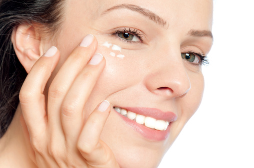 Skin care woman putting face cream