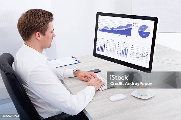 Young Businessman Using Computer At Desk Stock Photo - Download Image Now - Adult, Adults Only, Business