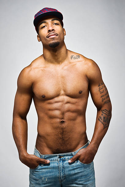 Shirtless muscular man standing Shirtless muscular man standinghttp://www.twodozendesign.info/i/1.png chest tattoo men stock pictures, royalty-free photos & images