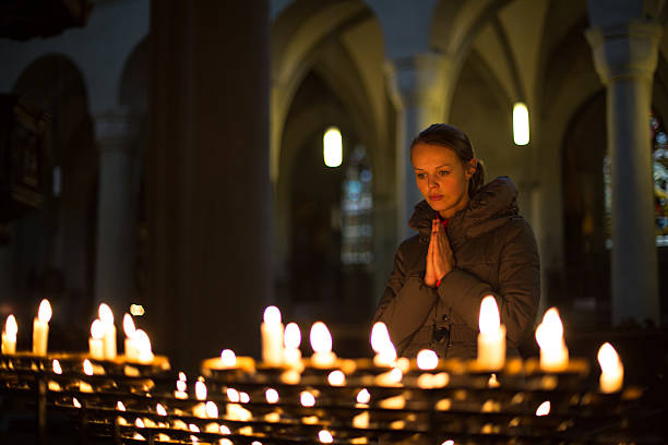 istock Young woman praying 465525776