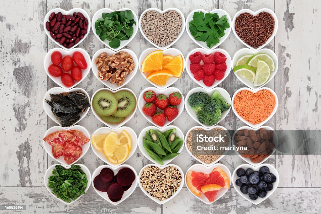 Detox Diet Food Diet detox super food selection in heart shaped porcelain bowls over distressed wooden background. 2015 Stock Photo