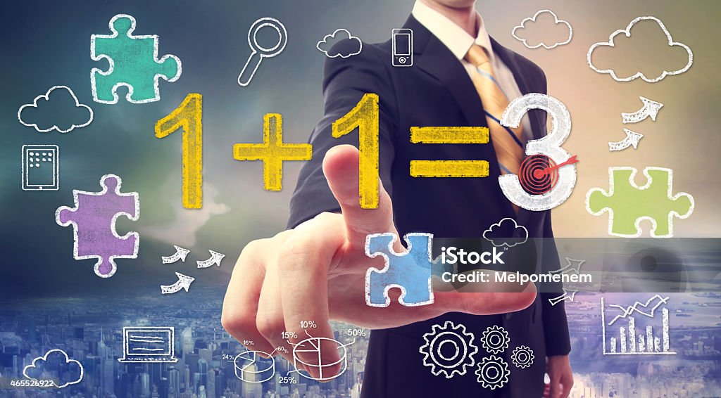 Synergy concept 1+1=3 Businessman pointing at synergy concept 1+1=3 with cartoon 2015 Stock Photo