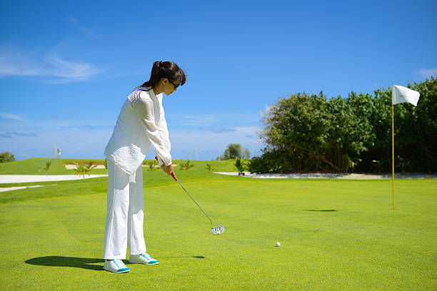 istock Beautiful Woman Playing Golf 465528345