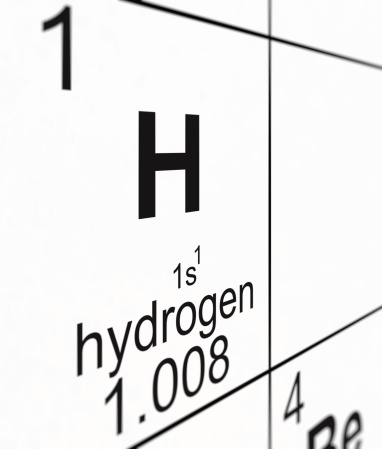 Detail of a partially blurred periodic table of the elements. Focus on hydrogen.