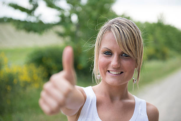 istock Young woman with thumbs up 465529499
