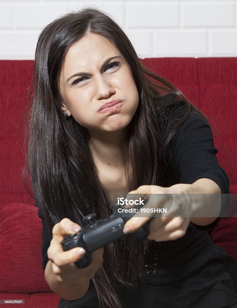 Female Gamer Attractive woman playing a video game. 20-24 Years Stock Photo