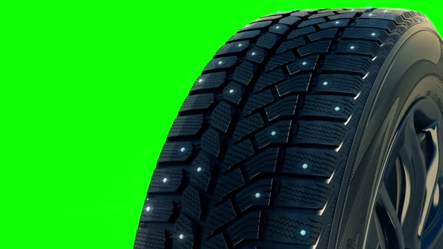Car studded winter tyre wheel rotate on camera in motion