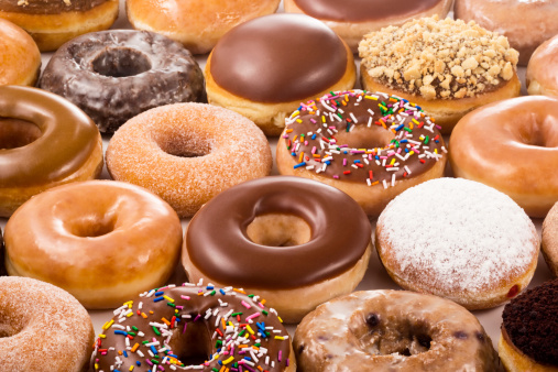 A field of donuts in many different flavors.