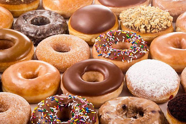 Field of Different Types of Donuts A field of donuts in many different flavors. doughnut stock pictures, royalty-free photos & images