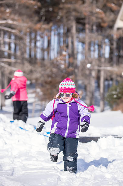 istock Two Young Girls Playing In Snow on Winter Day 465530612