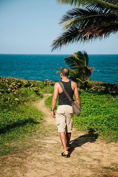 istock Man hiking by sea grass 465531941