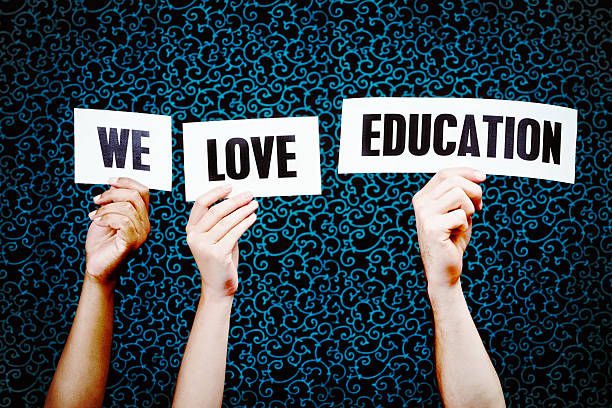 istock Hand-held signs say 'We love Education' 465532363