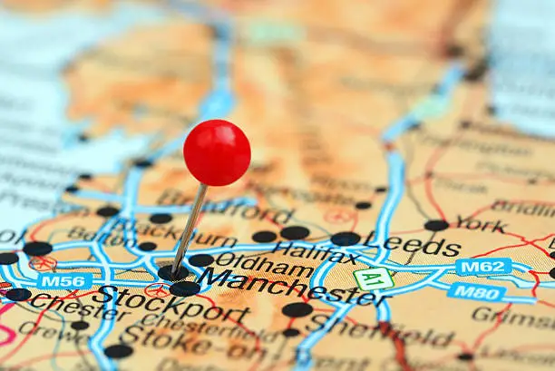 Photo of pinned Manchester on a map of europe. May be used as illustration for traveling theme.