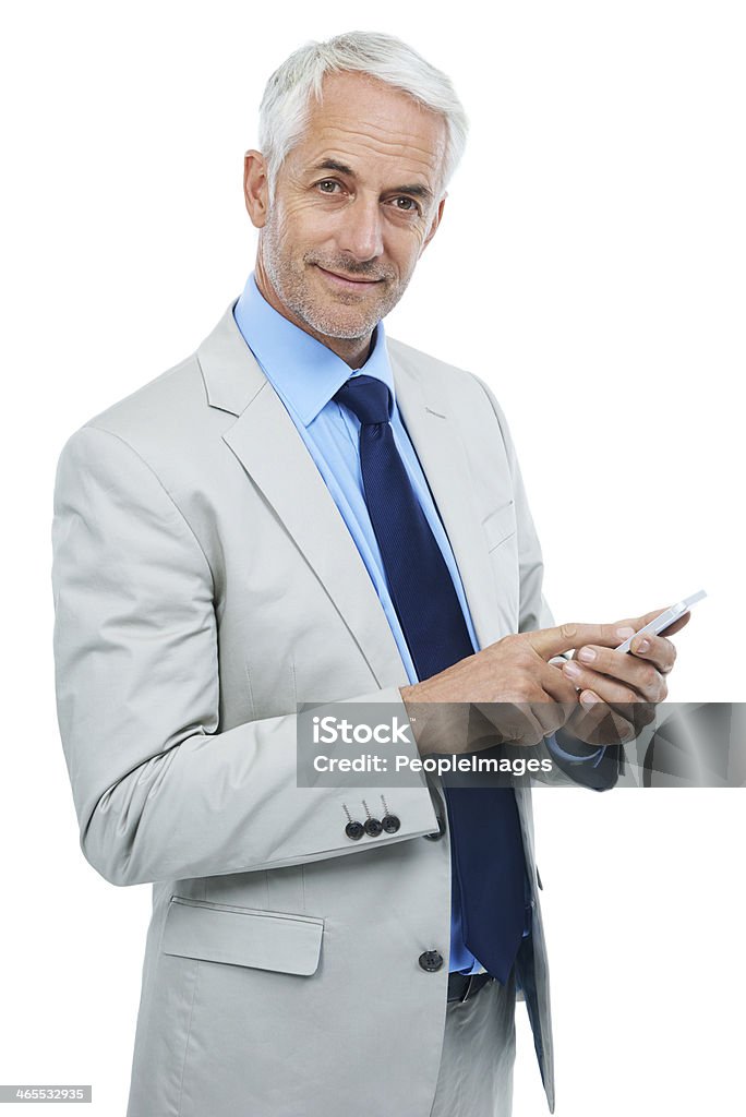 You can reach me anytime Studio portrait of a mature businessman using a cellphone isolated on white Business Stock Photo