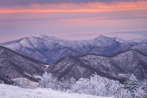 A winter sunset with snow-covered mountains along the Appalachian Trail on Round Bald at Roan Mountain.